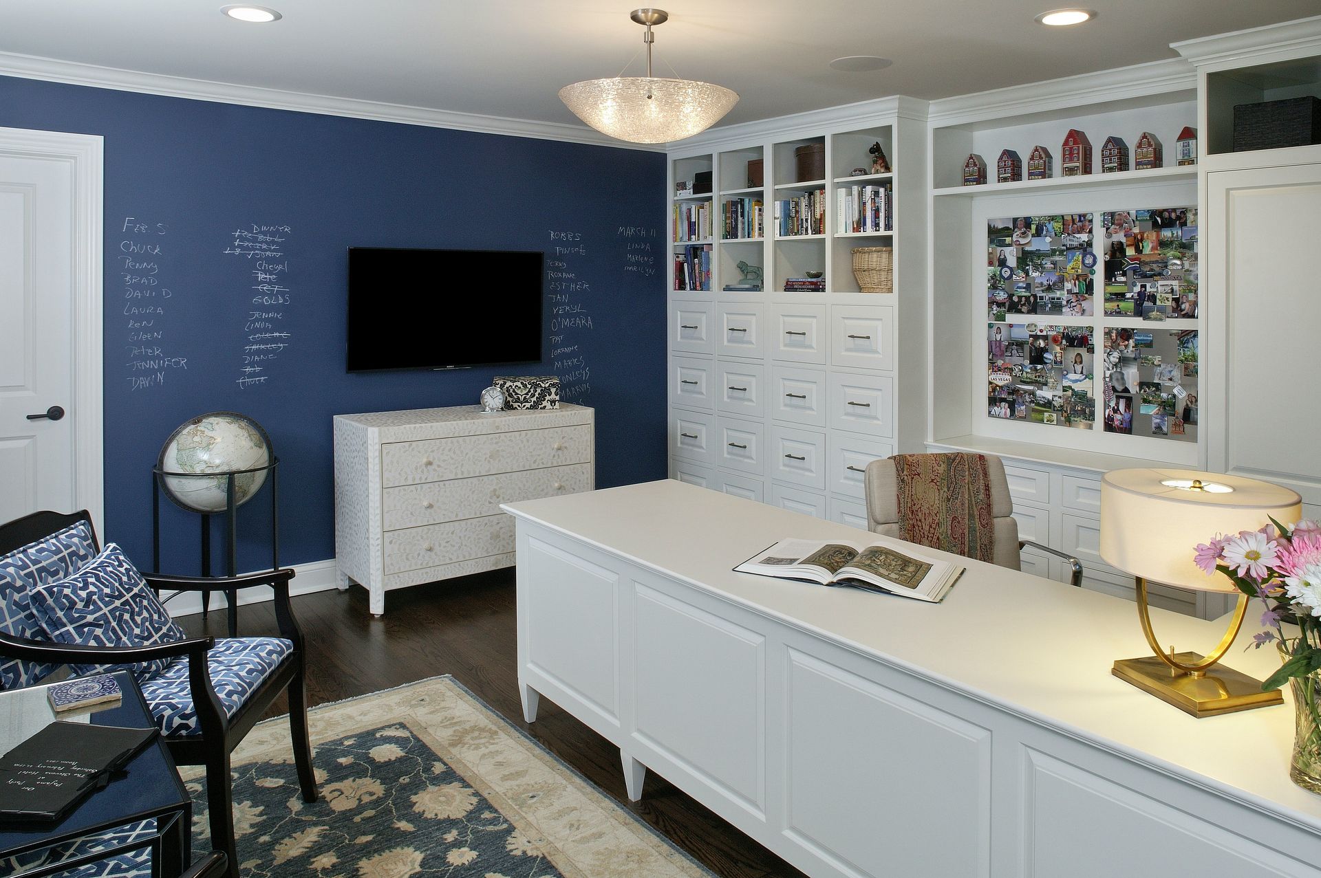 A living room with blue walls and white furniture and a flat screen tv